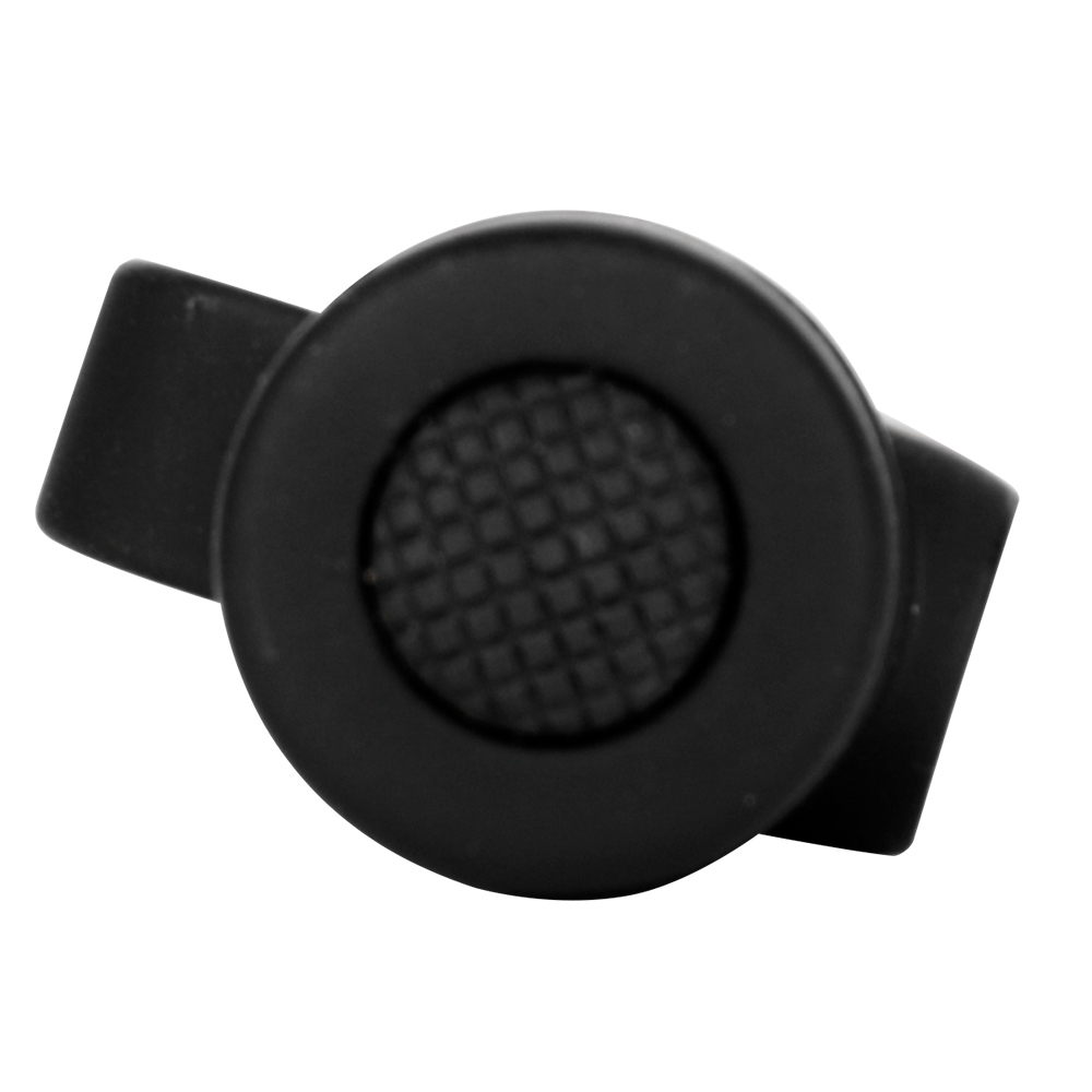 Close-up macro view focusing on the round black textured rubber tactical button switch on the tail cap.