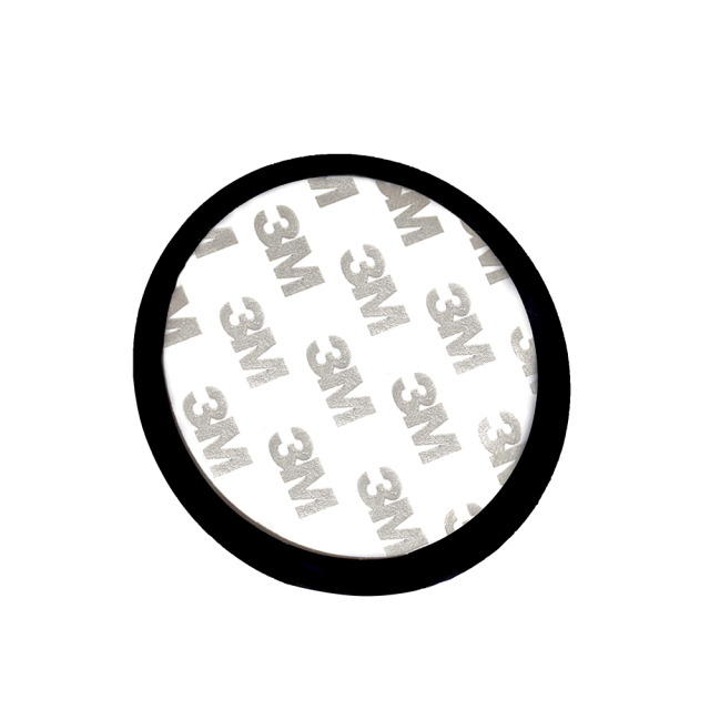 Close up view of a circular double-sided adhesive mounting tape pad featuring printed 3M logos.