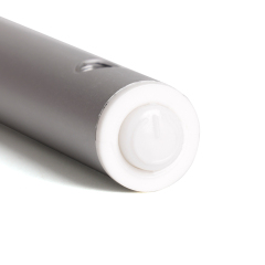 Close up view of the circular white plastic power switch button located at the tip of the silver light bar.