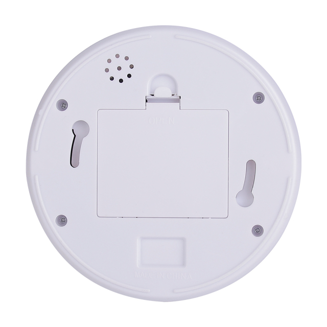 Rear view of the circular camera base plate showcasing a central square battery cover slot, two mounting keyholes, and a small perforated hole grid.