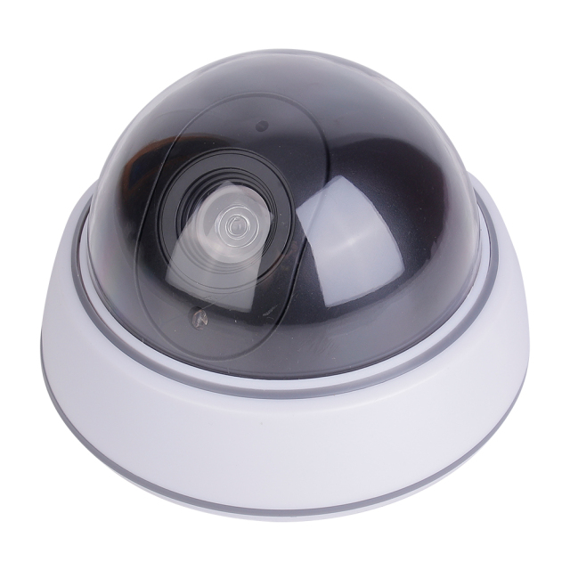 Side perspective view of the dome-shaped fake security camera showing the curved profile of the dark transparent shield and plastic casing on a white background.