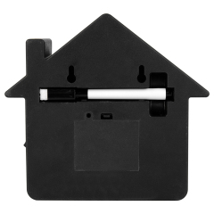 Rear view of the black plastic back panel, showing two wall-mounting keyholes, a battery compartment cover, and a built-in horizontal slot holding a white pen.