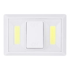 Straight-on front view of the white cordless closet light highlighting the central large rocker switch and dual vertical COB LED lighting panels.