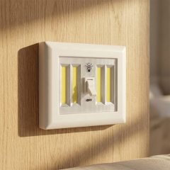 A rectangular white COB LED wall switch light mounted on a wooden panel under bright ambient light, demonstrating practical home installation.