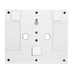 Rear view of the white switch light housing, displaying the flexible mounting hardware including built-in circular magnets, adhesive velcro pads, and a keyhole slot.