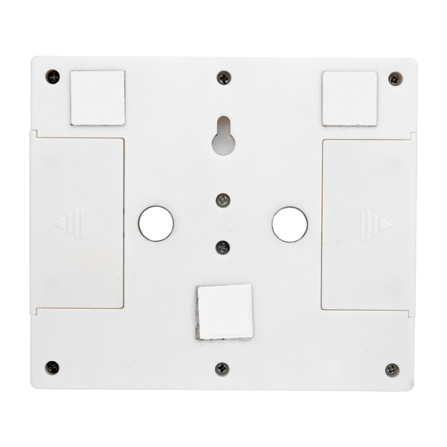 Rear view of the white switch light housing, displaying the flexible mounting hardware including built-in circular magnets, adhesive velcro pads, and a keyhole slot.