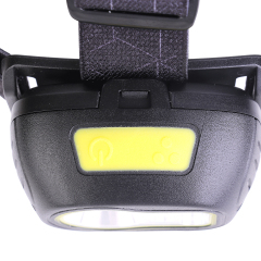 A top-down close-up view focusing on the dual-button control pad integrated into the top casing, featuring two distinct light green rubber push switches for separate mode operation.