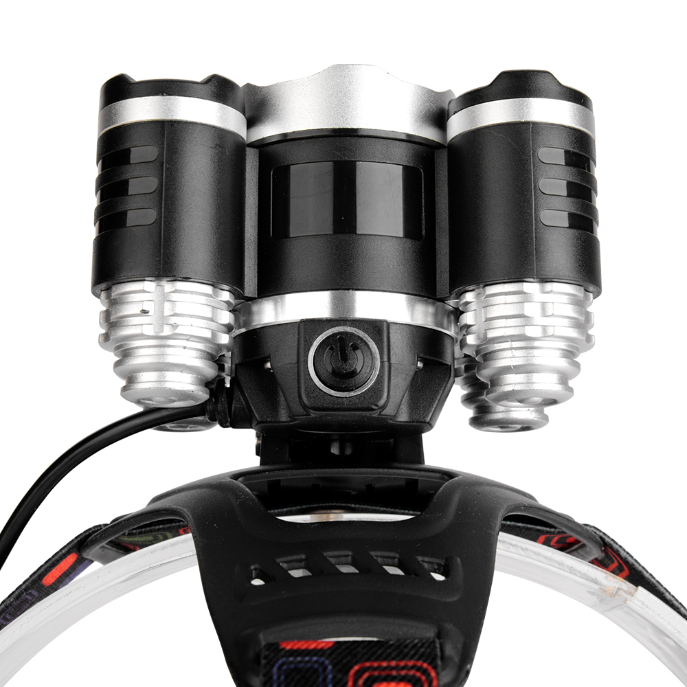 Studio top-down view of the multi-lens headlamp assembly, showing the aligned metal casing ridges, the pivoting mounting bracket, and the connected power cord.