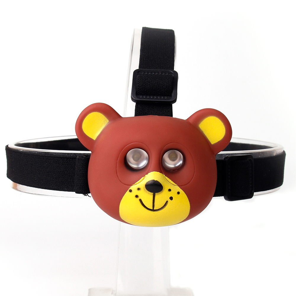 Studio front view of a brown and yellow cartoon bear-shaped custom kids head torch with dual embedded lights.