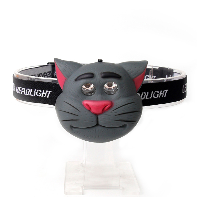 Studio front view of a grey custom cartoon cat-shaped kids head torch with dual lenses integrated into the eye sockets.