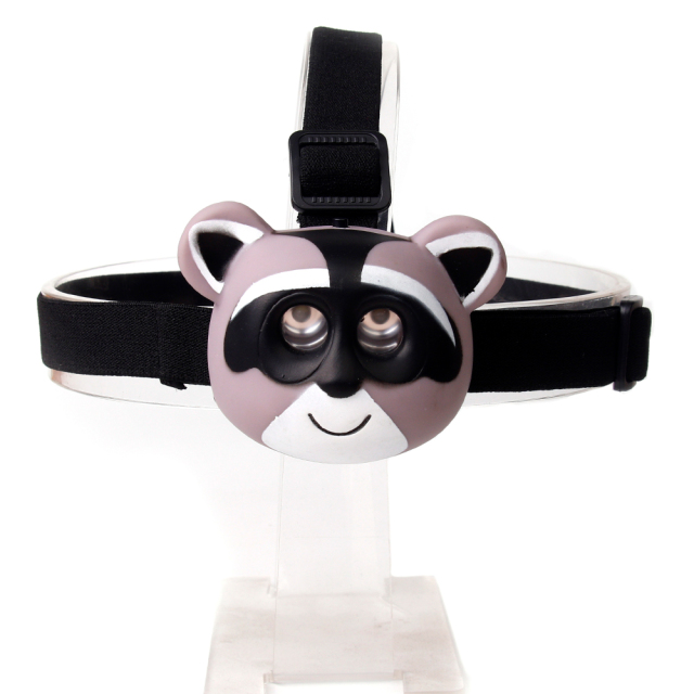 Studio front view of a custom grey and pink cartoon raccoon-shaped head torch displaying the dual lens layout.