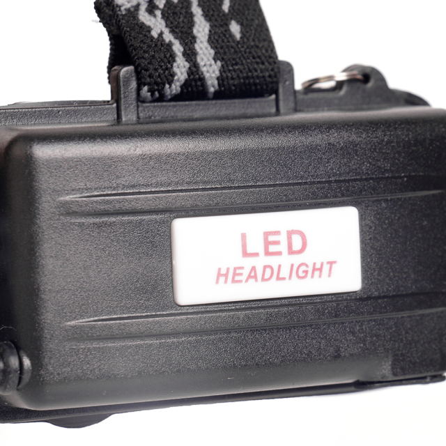 Close-up studio view of the rugged black plastic rear battery pack, featuring horizontal reinforcement lines and a central white label printed with red text.