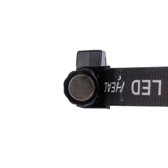 Studio side view close-up focusing on the flat circular utility magnet embedded on the end cap of the cylindrical housing for hands-free stationary mounting.