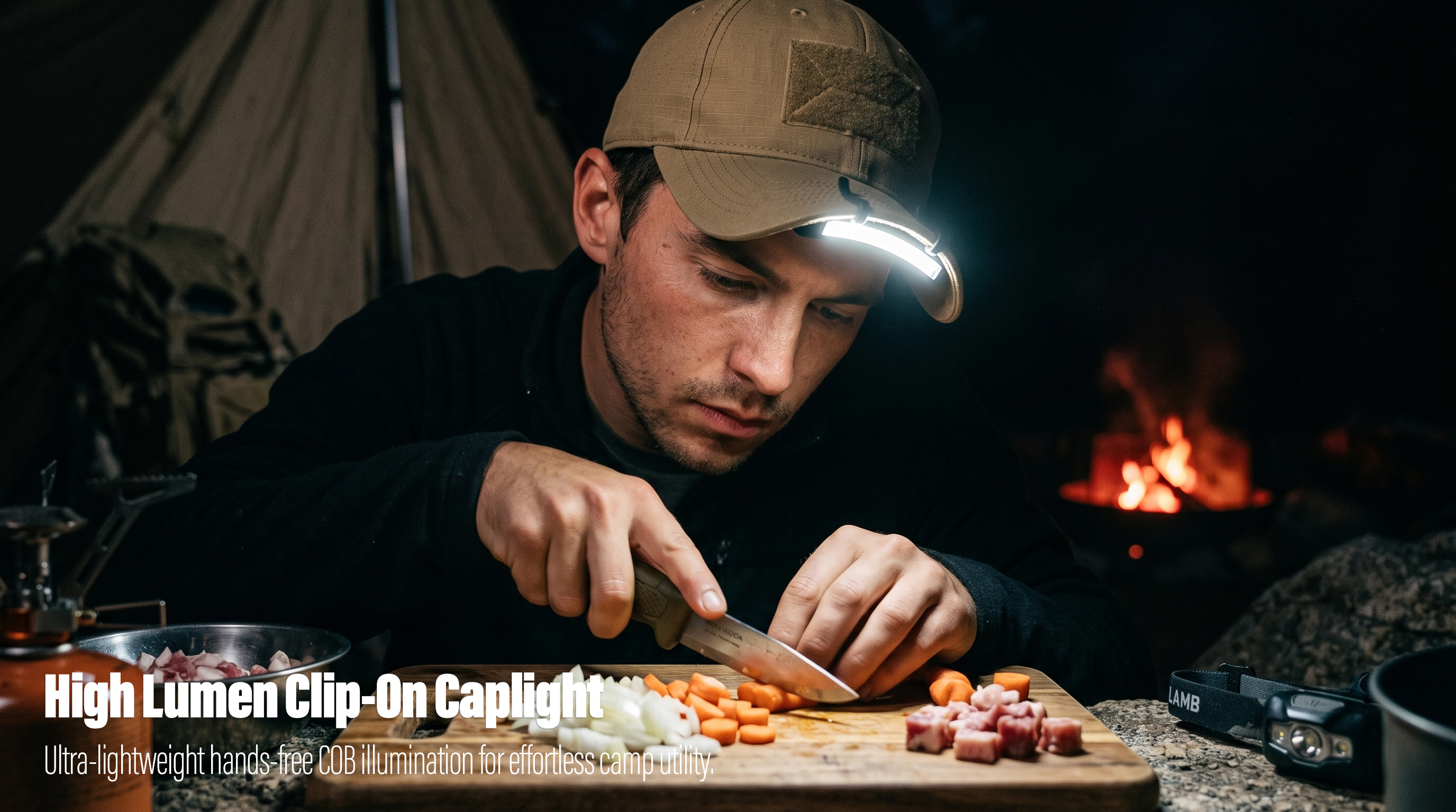 A close-up real-world photo of a male camper at night, wearing a tan cap with a bright COB LED caplight clipped to the brim, casting a direct beam on a cutting board as he prepares ingredients with a knife; a lit campfire and tent are in the background.