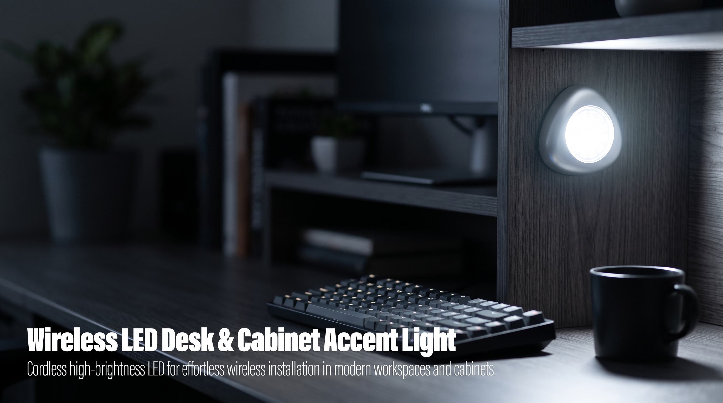 An illuminated unique teardrop-shaped silver wireless LED light mounted on a dark wood panel at a modern workspace, casting light on a black mechanical keyboard and a mug.