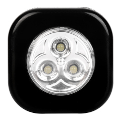 Studio front view of a black rounded-square wireless puck light featuring three integrated LEDs in a circular reflective center.