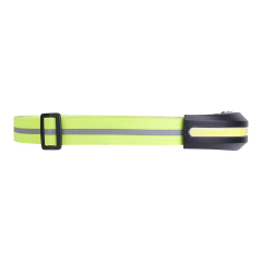Studio side profile view focusing on the long lime green headband with its gray reflective strip and a black plastic slider adjustment buckle.
