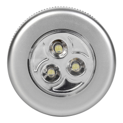 Studio front view of a silver round wireless puck light featuring three integrated LEDs in a circular reflective center.