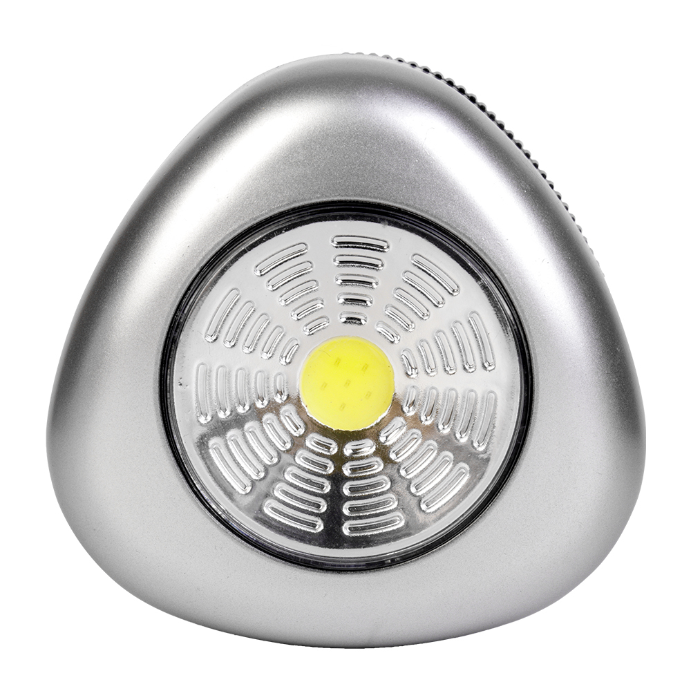 Studio front view of a silver triangular wireless puck light featuring a large circular COB LED panel with a yellow center.