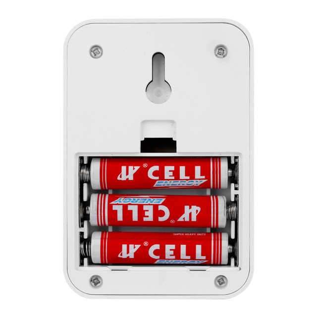 Studio view of the open battery compartment on the back of the switch light, showing three red and white AAA batteries installed inside the slots below the mounting keyhole.
