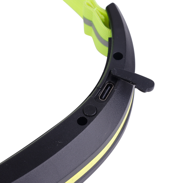 Studio close-up view of the inner curved section of the black housing, detailing the built-in Type-C USB charging port with its black rubber protective dust cover pulled open.