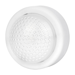 Studio angled view of the white round wireless dome LED puck light, showcasing the textured surface of the circular translucent cover.