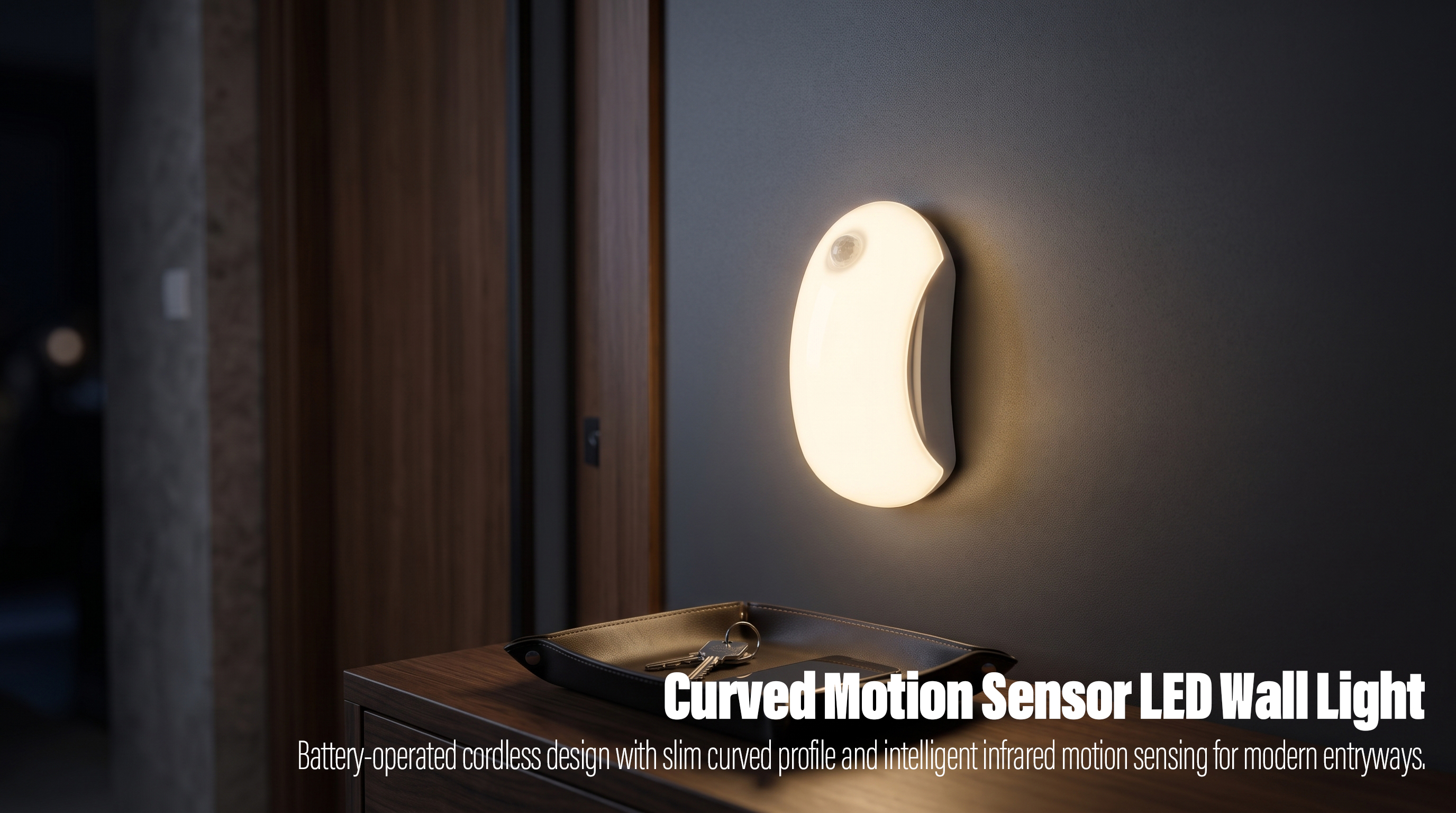An illuminated white curved crescent-shaped wireless motion sensor LED light mounted on a dark gray wall above a wooden entryway table with a leather key tray.
