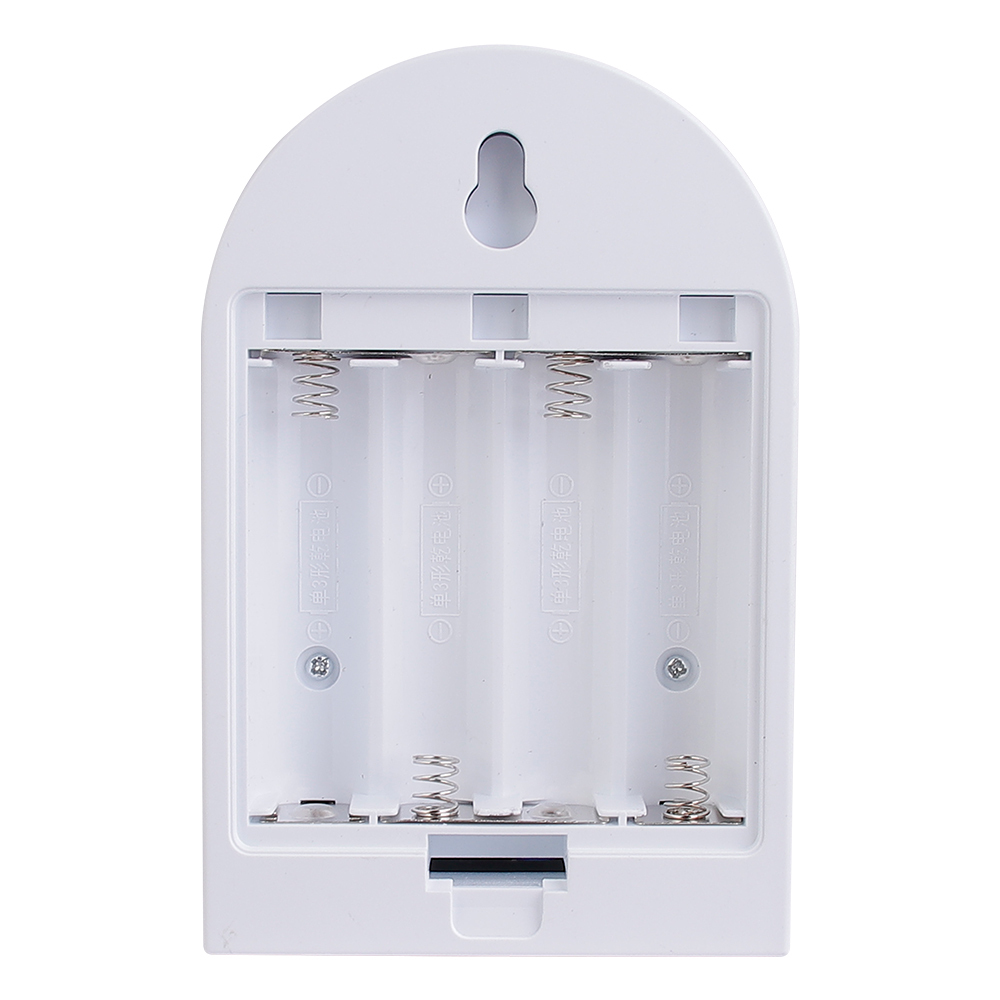 Studio view of the open internal battery compartment on the back of the arched night light, showing contact springs for four AA batteries.