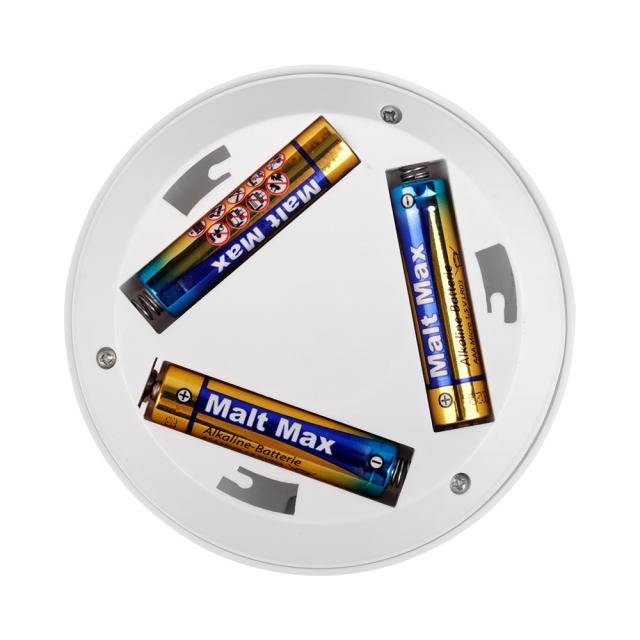 Studio view of the open internal battery compartment on the back of the circular light, showing three AAA batteries installed in a triangular configuration inside the twist-off base.