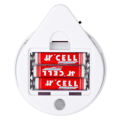 Studio view of the open battery compartment inside the unscrewed teardrop housing, showing three red AAA batteries installed in a row.