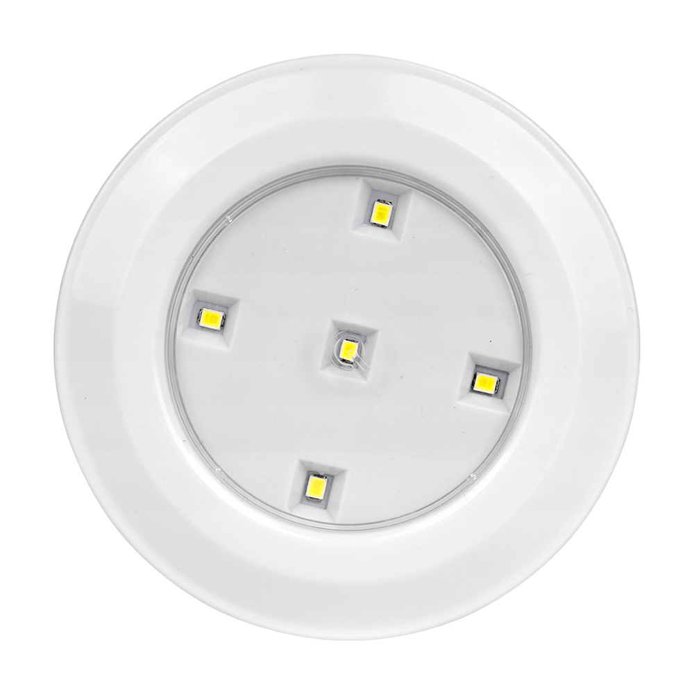 Studio straight front view of the circular LED puck light, featuring five individual small LED diodes arranged symmetrically on a silver reflector plate inside the white housing.