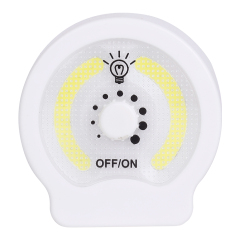 Studio front view of the circular dual COB LED night light, featuring a central rotary dimmer knob with dots for brightness adjustment and OFF/ON labels.