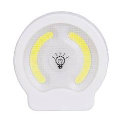 Studio front view of the circular dual COB LED wall light, featuring a central push button switch with a light bulb icon between two curved COB panels.
