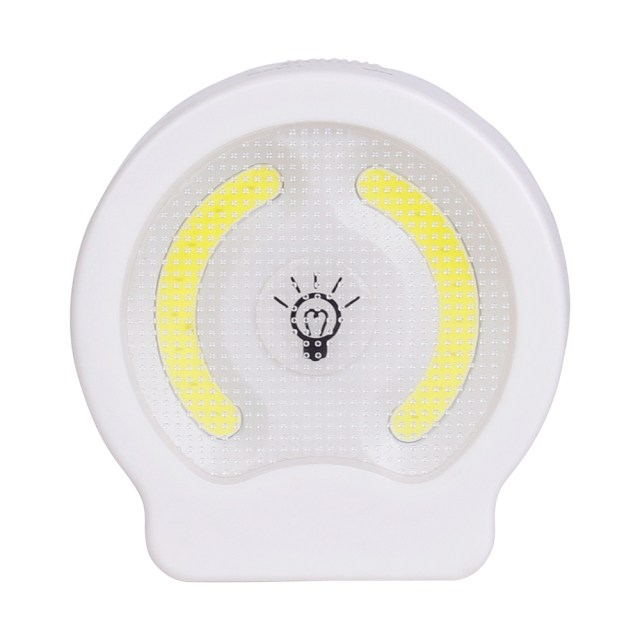 Studio front view of the circular dual COB LED wall light, featuring a central push button switch with a light bulb icon between two curved COB panels.