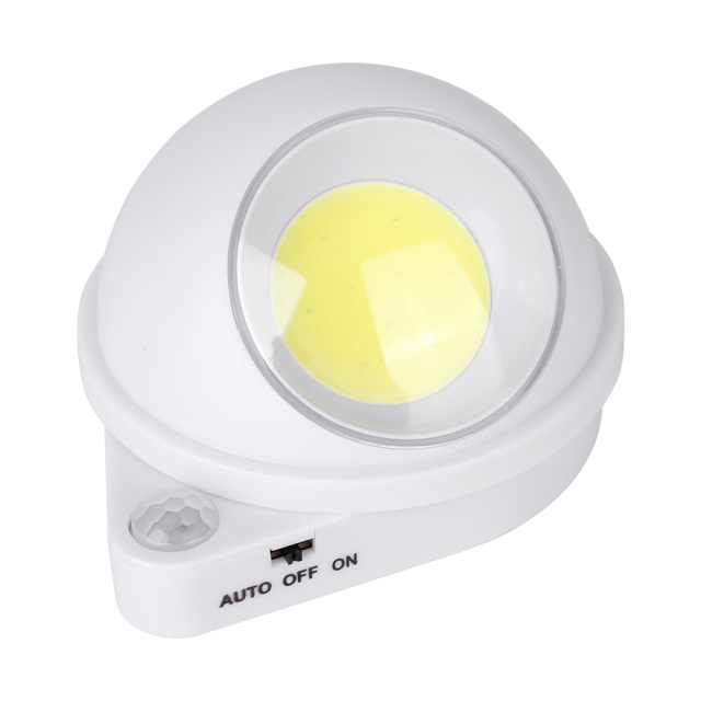 Studio front angle view of the spherical LED motion sensor light, featuring a round yellow COB light source and a circular PIR sensor on the teardrop base.