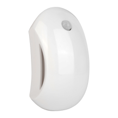 Studio angled front view of the white curved wireless LED sensor night light, showcasing its contoured ergonomic outer casing.