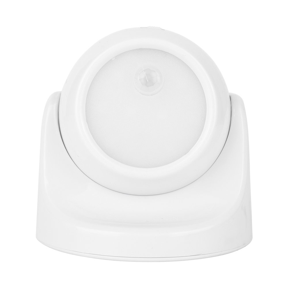 Studio front view of a white spherical wireless motion sensor light inside its curved mounting base, with the circular lens facing forward.