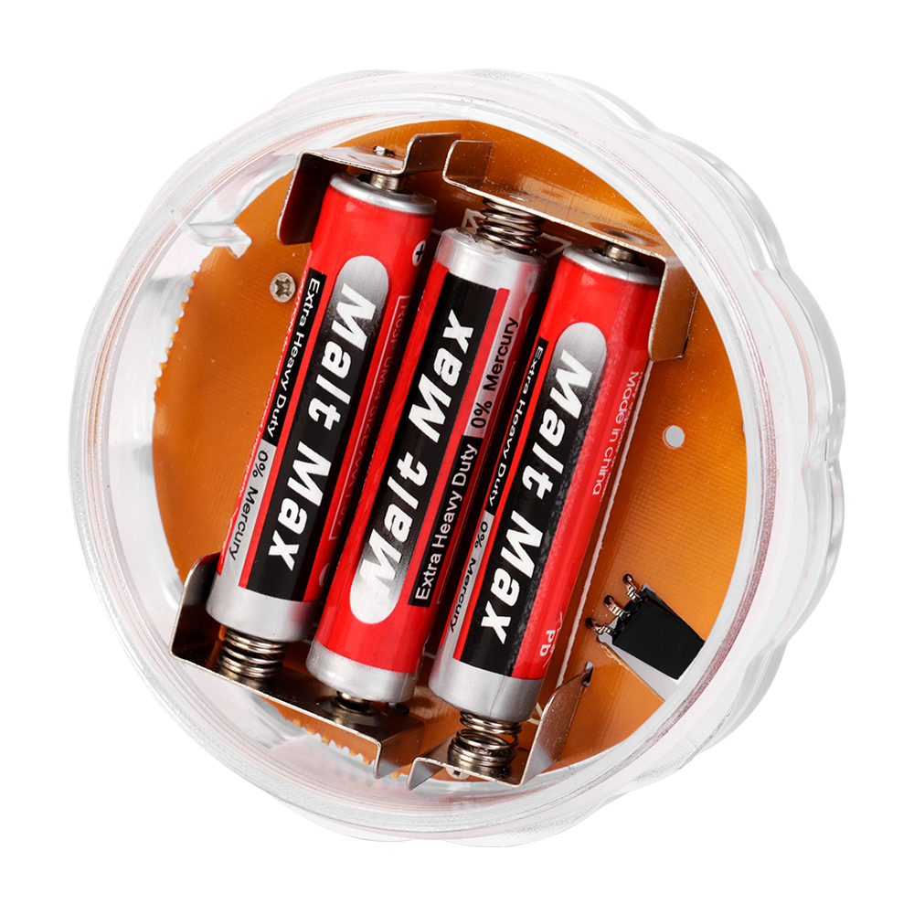 Studio view of the opened round submersible light, exposing the internal battery compartment holding three AAA batteries on an orange circuit board.