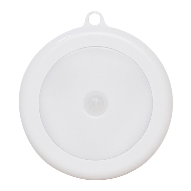 A direct front view of the round white PIR motion sensor LED night light on a clean white background, showcasing its dome diffuser and central sensor.