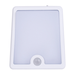 Studio front view of the white square smart LED night light, showcasing its large frosted diffuser panel and a circular PIR motion sensor at the bottom.