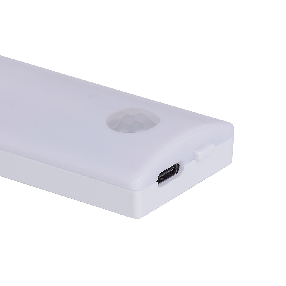 Close-up studio view of the white closet light bar, highlighting the built-in dome PIR motion sensor and the Type-C USB charging port.