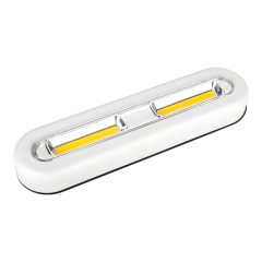 Studio three-quarter angle view of the white oval-shaped wireless COB LED cabinet light bar, displaying its smooth plastic housing and rounded edges.