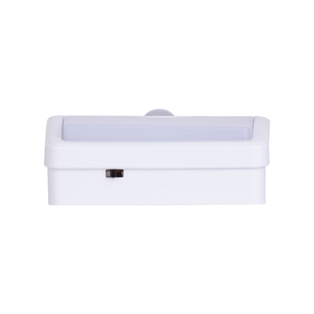 Studio top view of the white LED night light, showcasing the integrated small black toggle switch for power control.