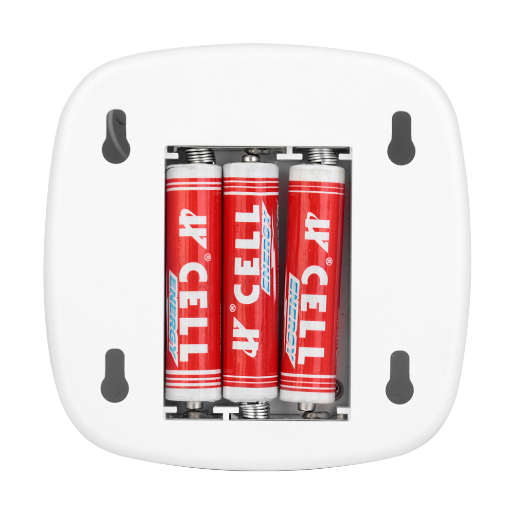 An open battery compartment on the back of the white night light, displaying three AAA batteries installed inside and dual wall-mounting keyholes.
