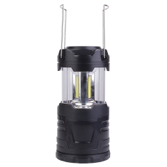 The opened collapsible LED camping lantern shown with its two stainless steel wire handles raised, highlighting the portability feature.
