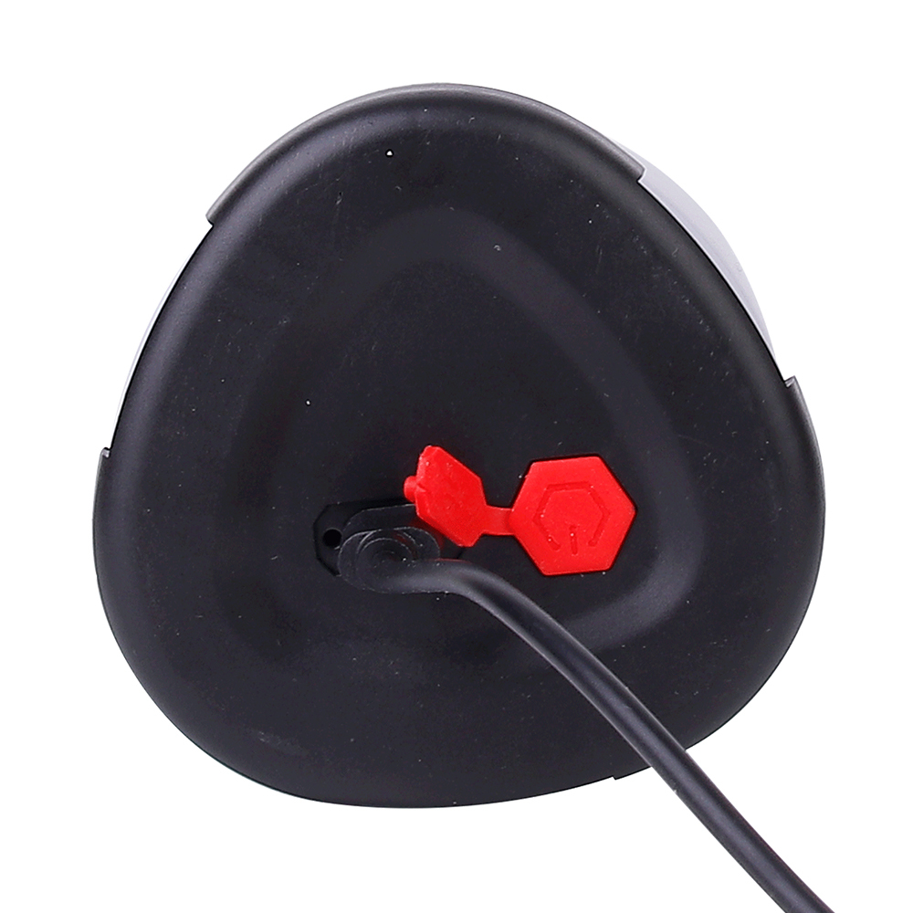 Close-up view of the rechargeable camping light base showing a USB cable plugged into the charging port next to an opened red rubber protective seal.