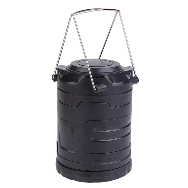 An angled view of the closed retractable camping light on a white background, emphasizing its rugged black body and compact storage size.