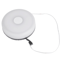 The round white retractable camping string light shown with a short portion of the LED wire and its ending USB plug extended.