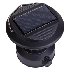 Top-down angled view focusing on the integrated monocrystalline solar charging panel built into the lid of the black vintage camping lantern.