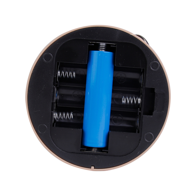 Detailed close-up view of the open bottom battery compartment of the lantern showing one blue 18650 battery in the middle and empty side slots for AA batteries.